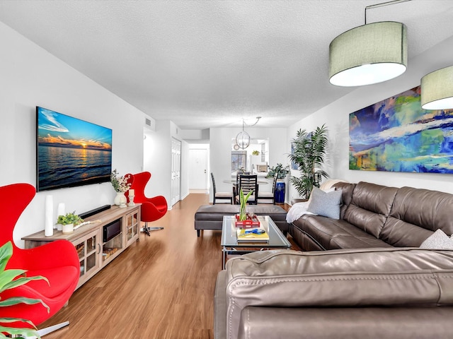 2027 SW 15th St Unit 177, Deerfield Beach, FL 33442 - living area with wood finished floors, a textured ceiling, and a chandelier