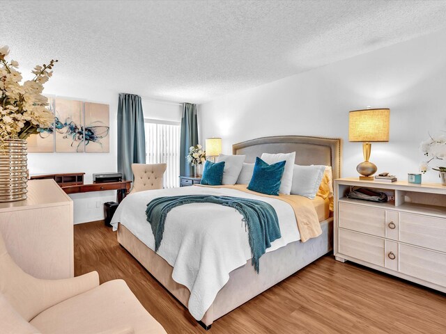 2027 SW 15th St Unit 177, Deerfield Beach, FL 33442 - bedroom with a textured ceiling and wood finished floors