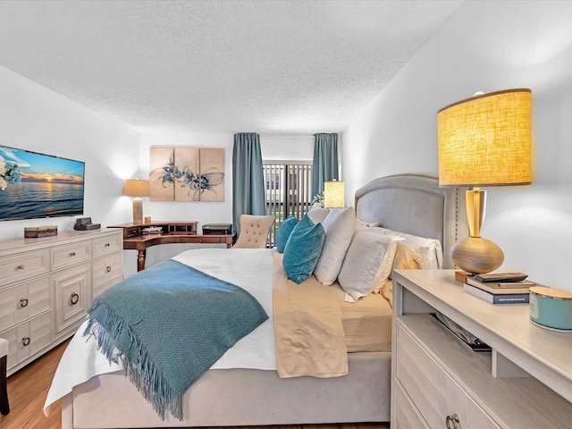 2027 SW 15th St Unit 177, Deerfield Beach, FL 33442 - bedroom with a textured ceiling and wood finished floors