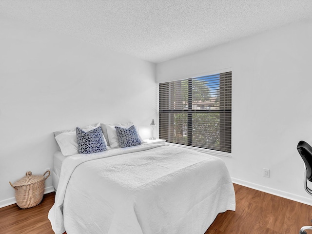 2027 SW 15th St Unit 177, Deerfield Beach, FL 33442 - bedroom featuring wood finished floors, a textured ceiling, and baseboards