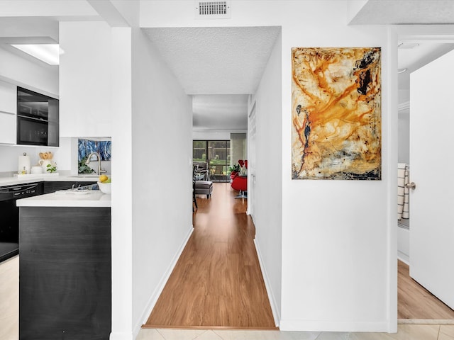 2027 SW 15th St Unit 177, Deerfield Beach, FL 33442 - corridor featuring light wood-style floors, a sink, and baseboards