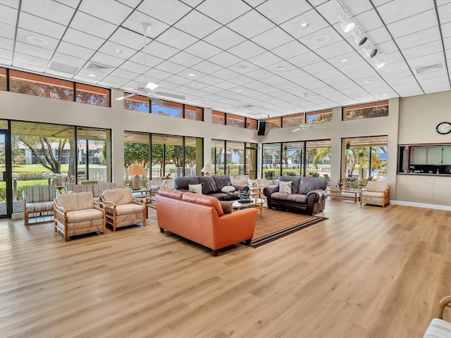 2027 SW 15th St Unit 177, Deerfield Beach, FL 33442 - living room featuring healthy amount of natural light, light wood-style floors, a high ceiling, a drop ceiling, and track lighting