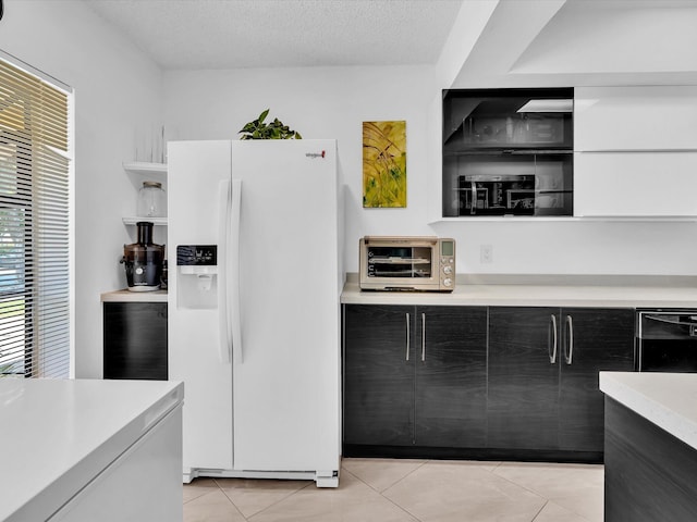 2027 SW 15th St Unit 177, Deerfield Beach, FL 33442 - kitchen with white fridge with ice dispenser, light countertops, light tile patterned flooring, dark cabinetry, and open shelves