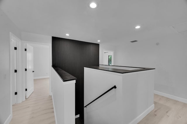 2033 SW Justison Ave, Port Saint Lucie, FL 34953 - corridor featuring an upstairs landing, light wood finished floors, baseboards, and recessed lighting