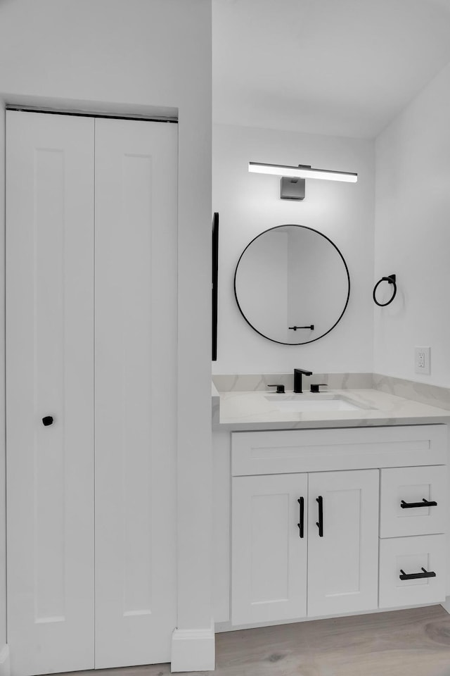 2033 SW Justison Ave, Port Saint Lucie, FL 34953 - bathroom featuring vanity and wood finished floors