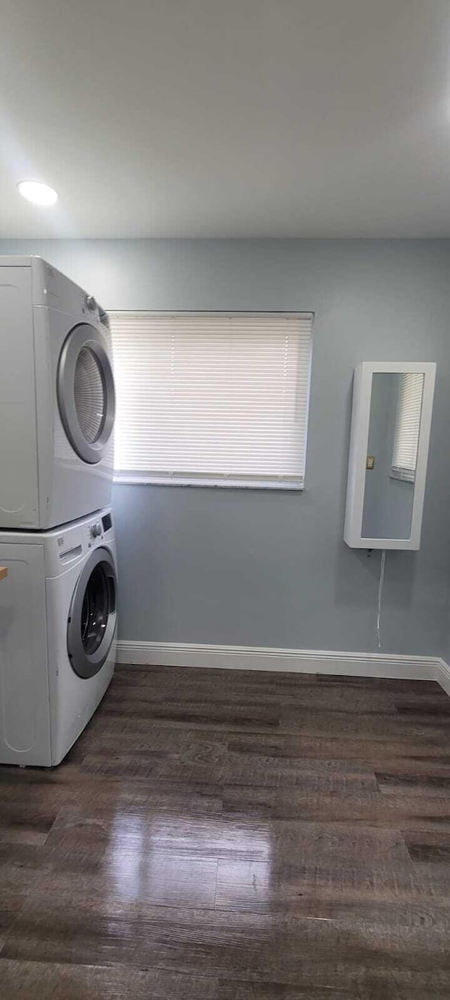 9258 N Military Trl, Palm Beach Gardens, FL 33410 - laundry area with estacked washer and dryer, baseboards, and dark wood-style floors