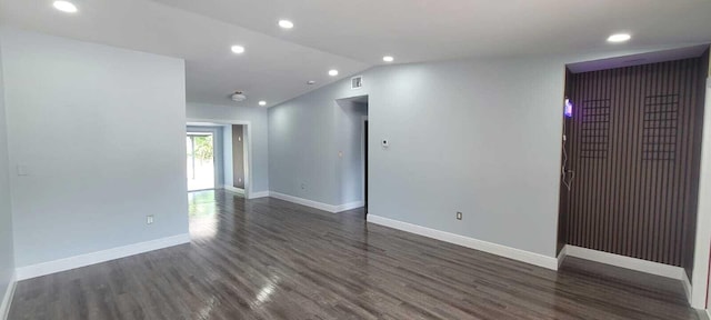 9258 N Military Trl, Palm Beach Gardens, FL 33410 - empty room featuring dark wood finished floors, baseboards, recessed lighting, and vaulted ceiling