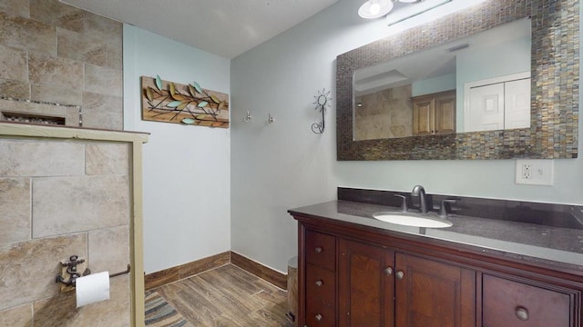 2569 SE Grand Dr, Port Saint Lucie, FL 34952 - bathroom featuring vanity, baseboards, and wood finished floors