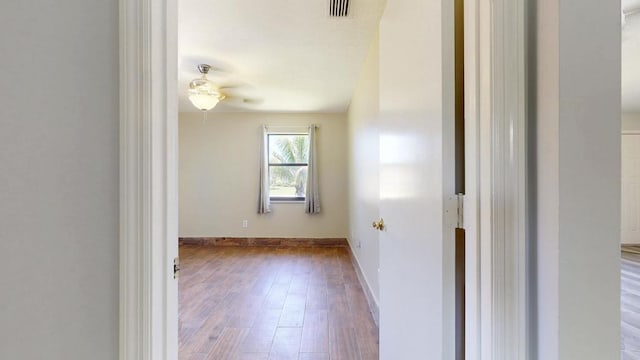 2569 SE Grand Dr, Port Saint Lucie, FL 34952 - empty room featuring a ceiling fan, wood finished floors, and baseboards