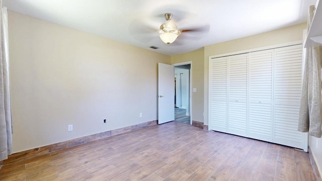 2569 SE Grand Dr, Port Saint Lucie, FL 34952 - unfurnished bedroom featuring wood finished floors, a closet, baseboards, and ceiling fan