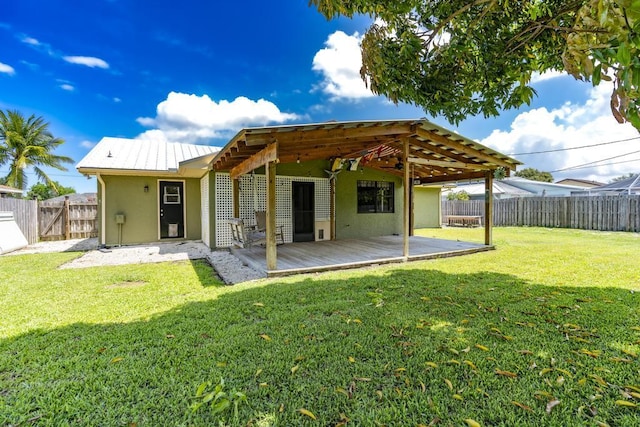 2569 SE Grand Dr, Port Saint Lucie, FL 34952 - rear view of house featuring stucco siding and a wooden deck