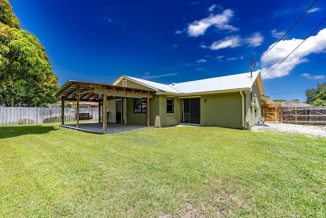 2569 SE Grand Dr, Port Saint Lucie, FL 34952 - rear view of house featuring stucco siding, a patio area, and metal roof