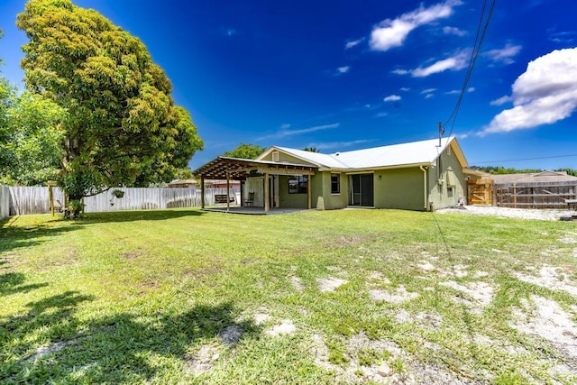 2569 SE Grand Dr, Port Saint Lucie, FL 34952 - back of house featuring stucco siding and a patio
