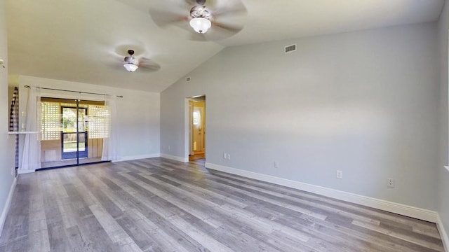 2569 SE Grand Dr, Port Saint Lucie, FL 34952 - spare room featuring a ceiling fan, baseboards, wood finished floors, and vaulted ceiling