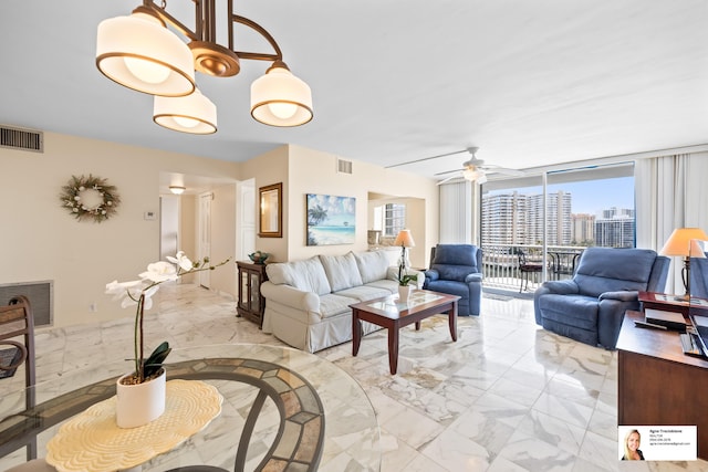 137 Golden Isles Dr Unit 804, Hallandale Beach, FL 33009 - living area with light marble finish flooring, ceiling fan, and floor to ceiling windows