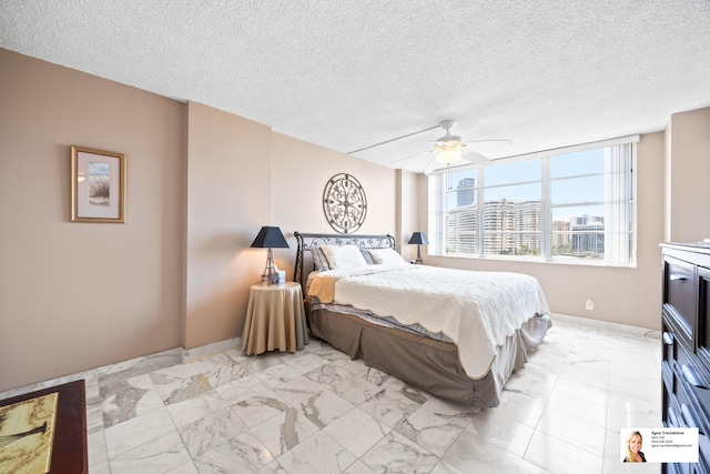 137 Golden Isles Dr Unit 804, Hallandale Beach, FL 33009 - bedroom featuring light marble finish floors, a textured ceiling, a ceiling fan, baseboards, and a view of city