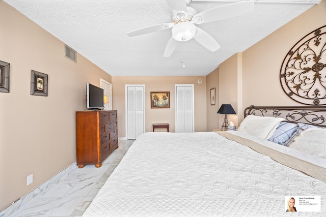 137 Golden Isles Dr Unit 804, Hallandale Beach, FL 33009 - bedroom with two closets, light marble finish floors, a textured ceiling, and a ceiling fan