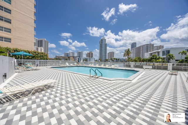 137 Golden Isles Dr Unit 804, Hallandale Beach, FL 33009 - community pool featuring a patio and a view of city