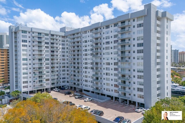 137 Golden Isles Dr Unit 804, Hallandale Beach, FL 33009 - view of building exterior featuring uncovered parking