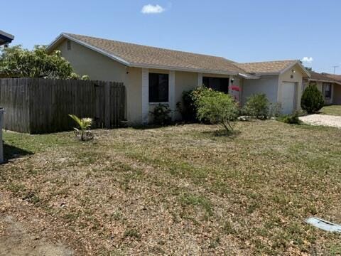 312 NW 18th Ct, Pompano Beach, FL 33060 - view of front of home with a garage and stucco siding