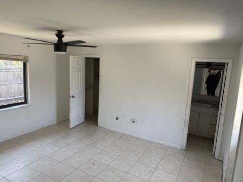 312 NW 18th Ct, Pompano Beach, FL 33060 - unfurnished bedroom featuring light tile patterned flooring, baseboards, and a closet