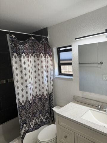 312 NW 18th Ct, Pompano Beach, FL 33060 - bathroom featuring vanity, shower / bathtub combination with curtain, and toilet