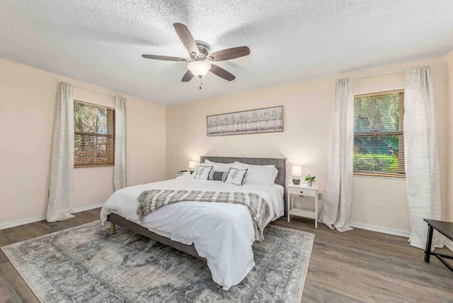 2550 SE Calais St, Port Saint Lucie, FL 34952 - bedroom with wood finished floors, baseboards, a textured ceiling, and ceiling fan
