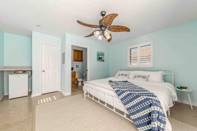 2550 SE Calais St, Port Saint Lucie, FL 34952 - bedroom with baseboards, ensuite bath, a ceiling fan, and fridge