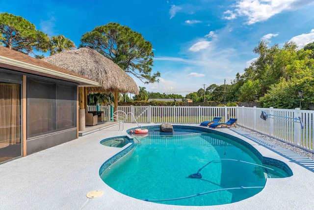 2550 SE Calais St, Port Saint Lucie, FL 34952 - view of pool with a fenced backyard, a patio area, and a pool with connected hot tub
