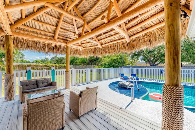 2550 SE Calais St, Port Saint Lucie, FL 34952 - deck featuring a gazebo, an outdoor living space, and a fenced backyard