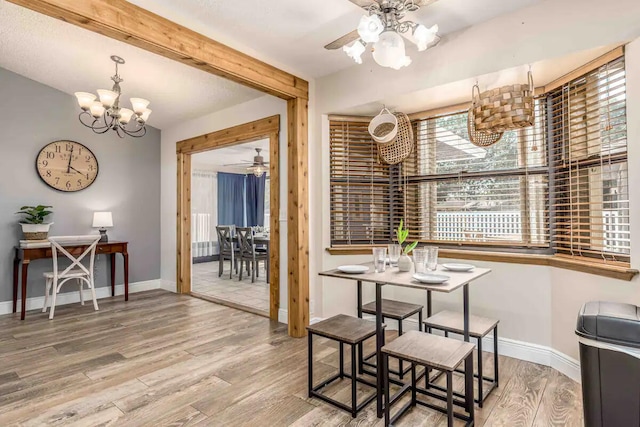 2550 SE Calais St, Port Saint Lucie, FL 34952 - dining space with a chandelier, ceiling fan, wood finished floors, and baseboards