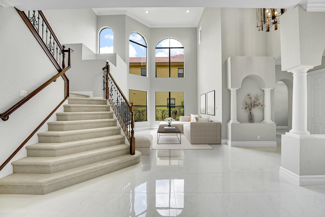 10523 Vignon Ct, Wellington, FL 33449 - entrance foyer with decorative columns, stairs, plenty of natural light, a high ceiling, and crown molding
