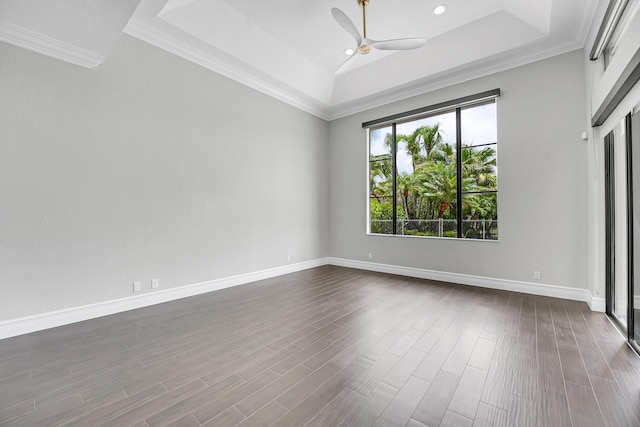 10523 Vignon Ct, Wellington, FL 33449 - spare room with a tray ceiling, a ceiling fan, ornamental molding, dark wood-style flooring, and baseboards