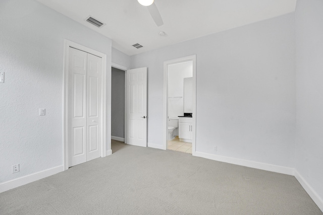 10523 Vignon Ct, Wellington, FL 33449 - unfurnished bedroom featuring light colored carpet, a closet, baseboards, connected bathroom, and ceiling fan