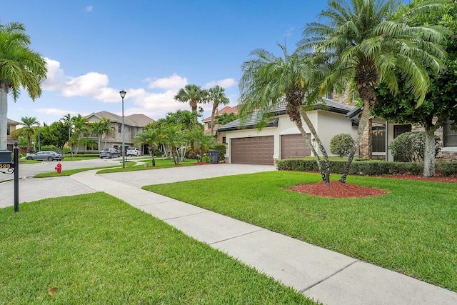 10523 Vignon Ct, Wellington, FL 33449 - view of front of house with driveway, stucco siding, a front yard, an attached garage, and a residential view