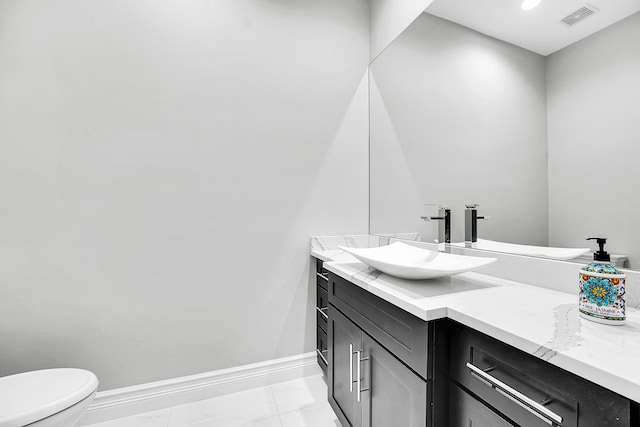 10523 Vignon Ct, Wellington, FL 33449 - bathroom with vanity, toilet, baseboards, and marble look tiles
