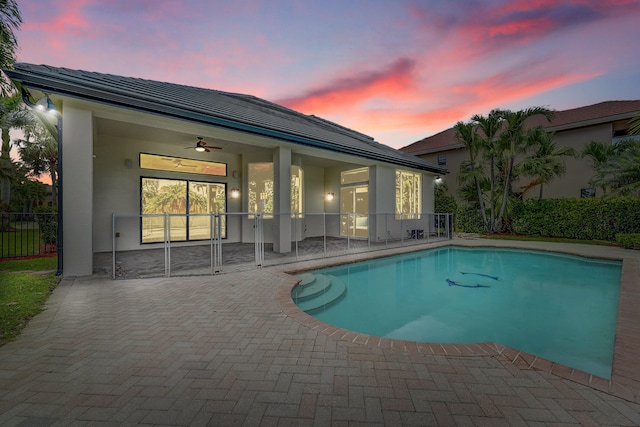 10523 Vignon Ct, Wellington, FL 33449 - pool at dusk featuring a patio area and a ceiling fan