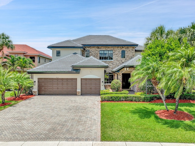 10523 Vignon Ct, Wellington, FL 33449 - french country inspired facade featuring stone siding, decorative driveway, a front yard, an attached garage, and stucco siding