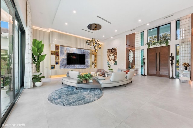 8533 N Native Dancer Rd, Palm Beach Gardens, FL 33418 - living area with a chandelier, a towering ceiling, recessed lighting, and concrete flooring