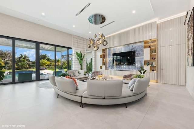 8533 N Native Dancer Rd, Palm Beach Gardens, FL 33418 - living area with concrete floors and a chandelier