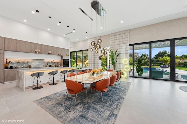 8533 N Native Dancer Rd, Palm Beach Gardens, FL 33418 - dining room with a high ceiling, recessed lighting, and light tile patterned floors
