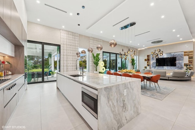 8533 N Native Dancer Rd, Palm Beach Gardens, FL 33418 - kitchen featuring modern cabinets, a sink, appliances with stainless steel finishes, a large island with sink, and recessed lighting