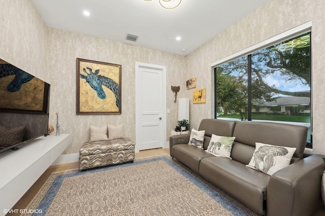 8533 N Native Dancer Rd, Palm Beach Gardens, FL 33418 - living area featuring wallpapered walls, baseboards, and recessed lighting