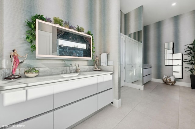 8533 N Native Dancer Rd, Palm Beach Gardens, FL 33418 - full bathroom with vanity, tile patterned floors, a towering ceiling, and baseboards