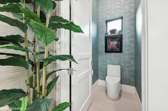 8533 N Native Dancer Rd, Palm Beach Gardens, FL 33418 - bathroom featuring wallpapered walls, baseboards, toilet, and tile patterned floors