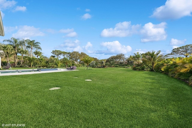 8533 N Native Dancer Rd, Palm Beach Gardens, FL 33418 - view of grassy yard featuring an outdoor pool