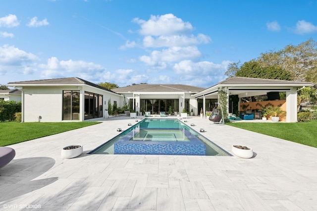 8533 N Native Dancer Rd, Palm Beach Gardens, FL 33418 - swimming pool featuring an in-ground hot tub, a patio area, a lawn, and an outdoor fire pit