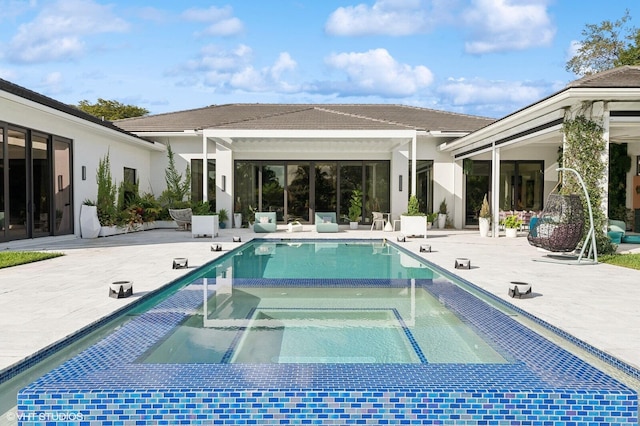8533 N Native Dancer Rd, Palm Beach Gardens, FL 33418 - view of swimming pool featuring a patio and a pool with connected hot tub