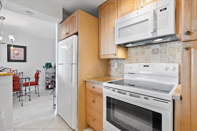 1009 N Ocean Blvd Unit 510, Pompano Beach, FL 33062 - kitchen with white appliances, tasteful backsplash, light countertops, and light brown cabinets