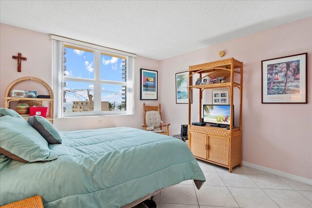 1009 N Ocean Blvd Unit 510, Pompano Beach, FL 33062 - bedroom featuring a textured ceiling, light tile patterned floors, and baseboards